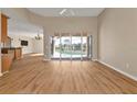 Bright living room with pool view and access, laminate floors, and kitchen view at 2262 Rio De Janeiro Ave, Punta Gorda, FL 33983