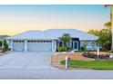Single-Gathering home with a three-car garage and well-maintained landscaping at 91 Mark Twain Ln, Rotonda West, FL 33947