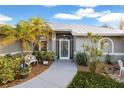 Welcoming front entrance with decorative landscaping and seating area at 91 Mark Twain Ln, Rotonda West, FL 33947