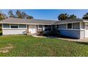 House exterior featuring a front porch and lawn at 18370 Inwood Ave, Port Charlotte, FL 33948