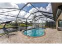 Relaxing pool area with a screened enclosure and lake view at 24211 Savory Ln, Punta Gorda, FL 33955