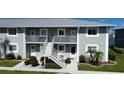 Exterior view of a two-story building with stairs at 3310 Loveland Blvd # 604, Port Charlotte, FL 33980