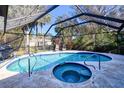 Screened pool and spa with comfortable seating area at 3173 S Cranberry Blvd, North Port, FL 34286