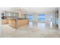 Modern kitchen with island, stainless steel appliances, and water views at 1 Colony Point Dr # 16B, Punta Gorda, FL 33950