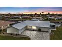 Single-story home on waterfront lot with paved driveway at 950 Genoa Ct, Punta Gorda, FL 33950