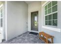 Front entrance with paver walkway and bench at 9973 Calumet Blvd, Port Charlotte, FL 33981