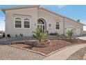 Tan house with a double garage and attractive landscaping at 171 Morgan Se Ln, Port Charlotte, FL 33952