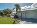 White single story house with metal roof and attached garage at 22465 Vale Ave, Punta Gorda, FL 33980