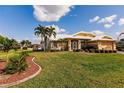 Single-story house with a well-manicured lawn and palm trees at 2868 Coral Way, Punta Gorda, FL 33950