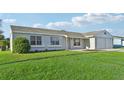 Single story home with two car garage and neatly landscaped yard at 8109 San Jacinto Ave, North Port, FL 34287
