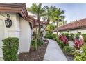 Lush tropical landscaping lining the walkway to the entrance at 956 Harbor Town Dr, Venice, FL 34292