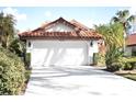 House exterior with double garage and landscaping at 956 Harbor Town Dr, Venice, FL 34292