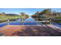 Wooden dock overlooks a peaceful canal, perfect for enjoying waterfront living at 18404 Lake Worth Blvd, Port Charlotte, FL 33948