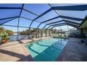 Enclosed pool area with tiled deck, offering a relaxing outdoor space at 18404 Lake Worth Blvd, Port Charlotte, FL 33948