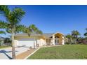 Single-story home with attached garage and landscaped yard at 18404 Lake Worth Blvd, Port Charlotte, FL 33948