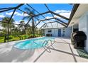 Relaxing pool and patio area with a grill at 1124 Cheshire St, Port Charlotte, FL 33953