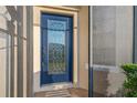 Front door with decorative glass accents, offering natural light and curb appeal at 2765 Arugula Dr, North Port, FL 34289
