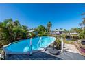 Relaxing rectangular pool with wooden deck overlooking the canal at 3111 Buttonwood Pl, Punta Gorda, FL 33950