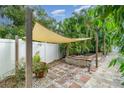 Relaxing backyard with pond, shade sail, and brick patio at 3164 Broad Ave, North Port, FL 34286