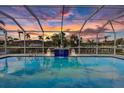 Relaxing pool area with water feature and sunset view at 941 Don Juan Ct, Punta Gorda, FL 33950