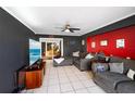 Living room with grey sectional sofa and large TV at 21451 Glendale Ave, Port Charlotte, FL 33952