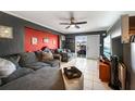 Living room with grey sectional sofa and backyard view at 21451 Glendale Ave, Port Charlotte, FL 33952