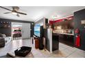 Open concept kitchen with dark cabinets and a breakfast bar at 21451 Glendale Ave, Port Charlotte, FL 33952