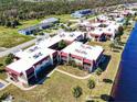 Aerial view of a waterfront community with multiple buildings and lush landscaping at 72 Boundary Blvd # 217, Rotonda West, FL 33947