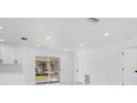 Bright and airy living room with access to a screened patio at 18289 Eblis Ave, Port Charlotte, FL 33948