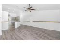 Open living room with grey vinyl flooring at 5895 Bannock Cir, North Port, FL 34288