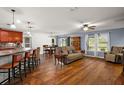 Open living room with hardwood floors, kitchen island, and a couch at 10122 Winding River Rd, Punta Gorda, FL 33950