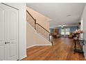 Hardwood floor entryway with staircase and view into the living room at 10122 Winding River Rd, Punta Gorda, FL 33950