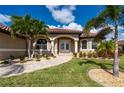 Attractive single-story home with tile roof, palm trees, and landscaped yard at 2736 Magdalina Dr, Punta Gorda, FL 33950