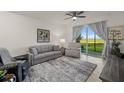 Living area with lake view, comfortable seating and large windows at 43050 Greenway Blvd # 614, Punta Gorda, FL 33982