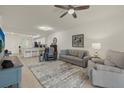 Spacious living room featuring a comfortable sofa and kitchen views at 43050 Greenway Blvd # 614, Punta Gorda, FL 33982
