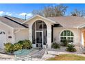 Charming home exterior with landscaped yard and screened entryway at 4793 S Salford Blvd, North Port, FL 34287