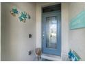 Front door entry with beach-themed decor at 7773 Mikasa Dr, Punta Gorda, FL 33950