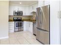 Modern kitchen with stainless steel appliances and white cabinets at 21150 Gertrude Ave # A3, Port Charlotte, FL 33952
