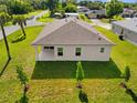 Aerial view of a backyard with a covered patio and well-manicured lawn at 1293 Preston St, Port Charlotte, FL 33952