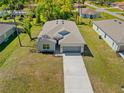 Aerial view of a single-Gathering home, showcasing the roofline and long driveway at 1301 Preston St, Port Charlotte, FL 33952