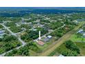 Aerial view of a home nestled amongst lush trees in a sprawling neighborhood at 1415 Nackman Rd, North Port, FL 34288