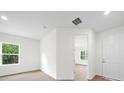 Bright and spacious hallway with light wood flooring at 1415 Nackman Rd, North Port, FL 34288