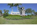 Entrance sign for Heritage Landing, a community with lush landscaping at 14271 Heritage Landing Blvd # 1526, Punta Gorda, FL 33955