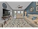 Bright living room featuring stylish furniture, a patterned rug, and sliding doors to a screened porch for indoor-outdoor living at 2000 Bal Harbor Blvd # 321, Punta Gorda, FL 33950
