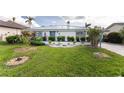 Landscaped front yard of a single-story home with a metal roof at 2241 Gulfview Rd, Punta Gorda, FL 33950