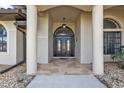 Elegant entryway with double doors, stone flooring, and columns at 25373 Tether Ln, Punta Gorda, FL 33983