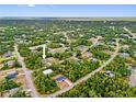 An aerial view of the neighborhood showcasing the property's location surrounded by lush greenery and nearby houses at 2643 Rushmore St, North Port, FL 34288