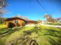 Side view of the house displaying the landscaping and house architecture at 301 Country Club Way, Venice, FL 34285
