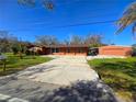 Front view of the property, showcasing the house, driveway, and detached garage at 301 Country Club Way, Venice, FL 34285