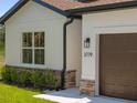 Close-up of the home's exterior, highlighting the stone accents, manicured landscaping, and the inviting entryway at 3779 Clearfield St, North Port, FL 34286